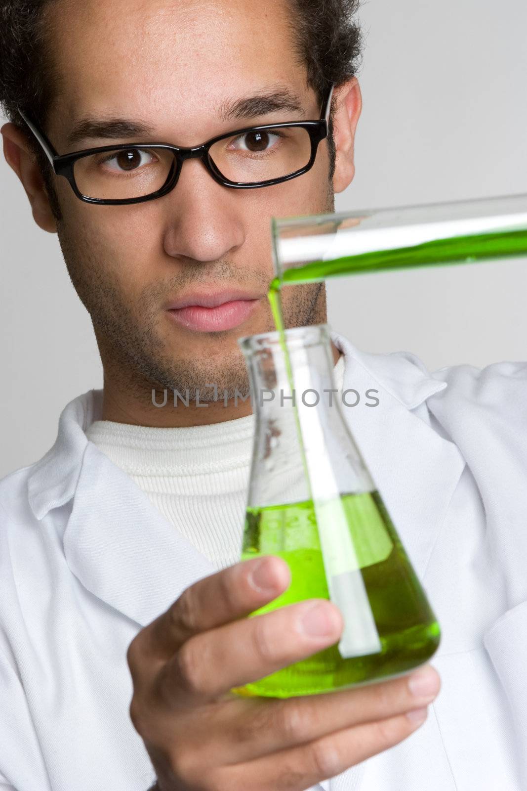 Man doing science experiment pouring liquid