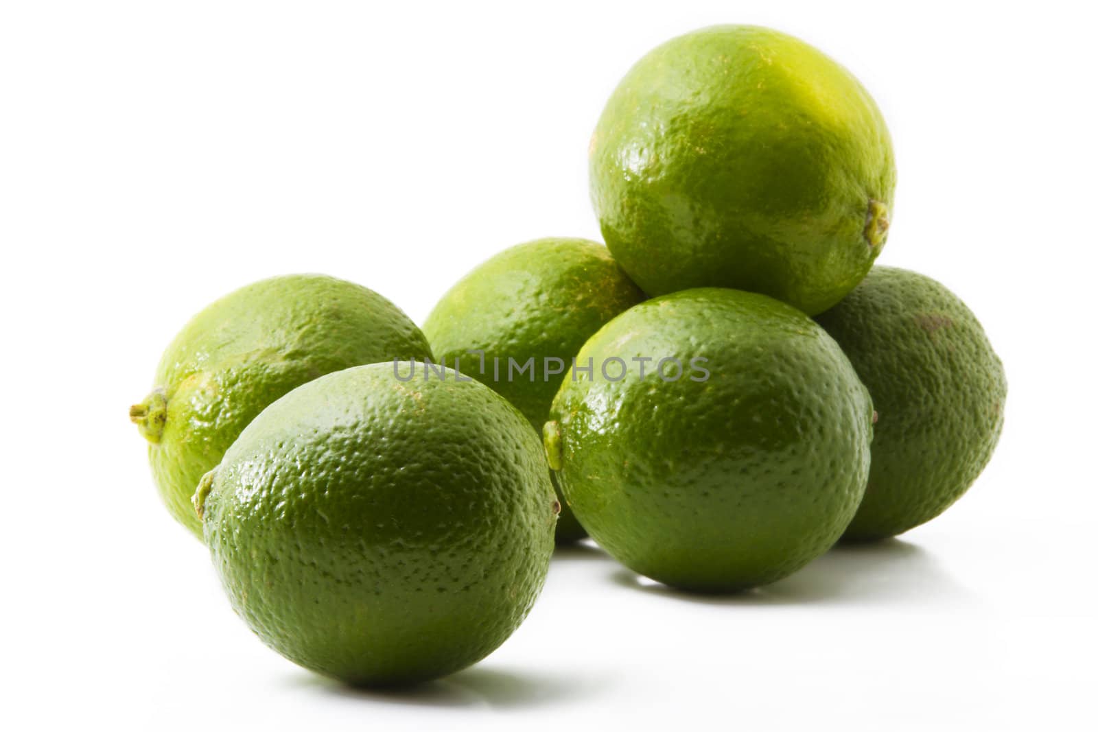 six green limes on white background