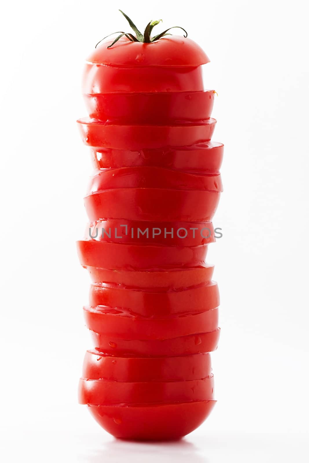 one tower made of tomato blades on white background
