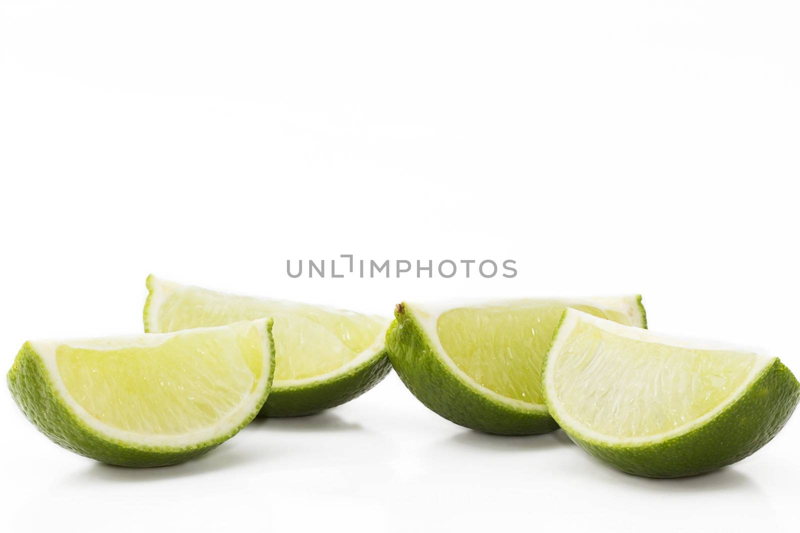 four lemon slices on white background