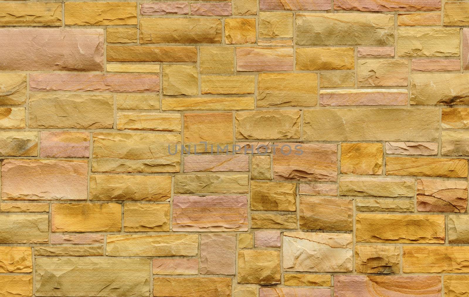 Seamless gold and pink masonry wall with irregular size rectangular stones. The texture repeats seamlessly both vertically and horizontally.
