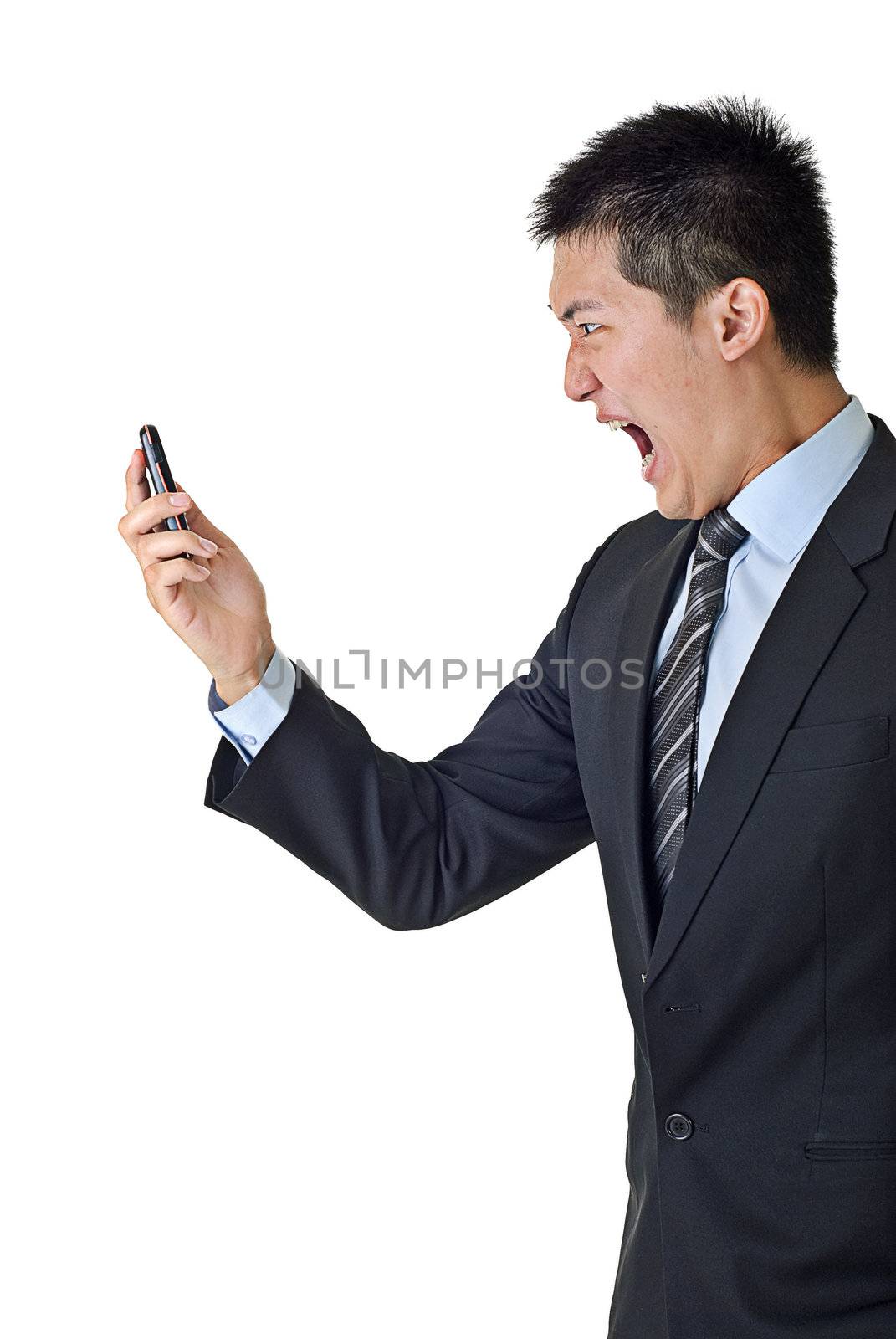 Angry businessman yelling to cellphone on white background.