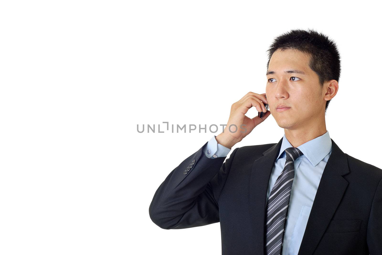 Young businessman listen on cellphone on white background.