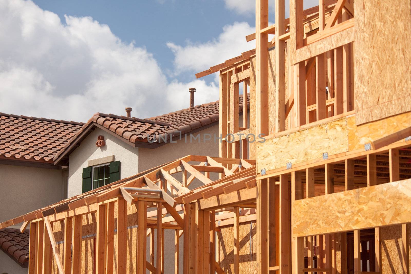 Abstract of New Home Construction Framing And Completed House.