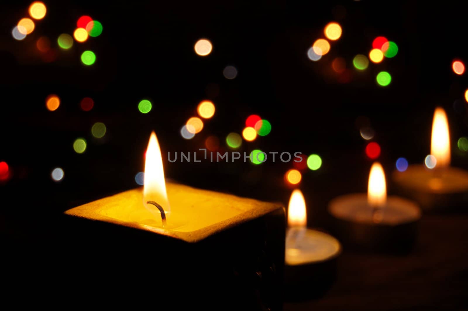 candles with colorful bokeh on back