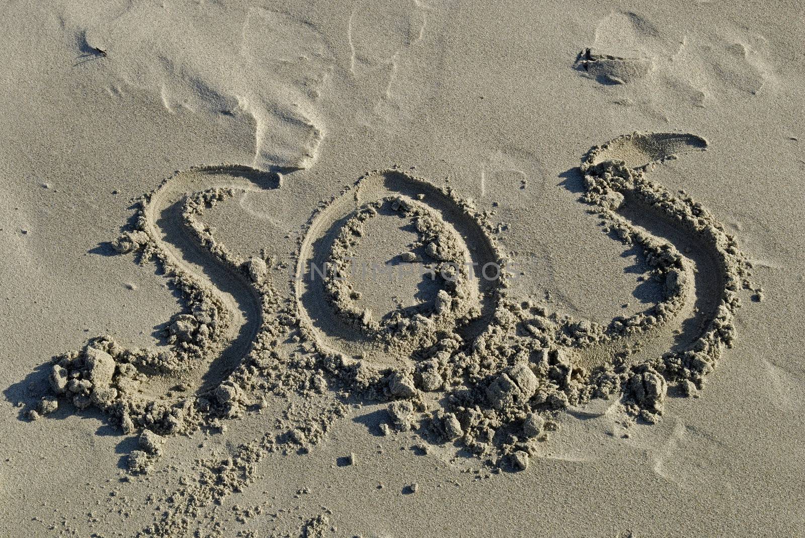 SOS Inscription written in sand