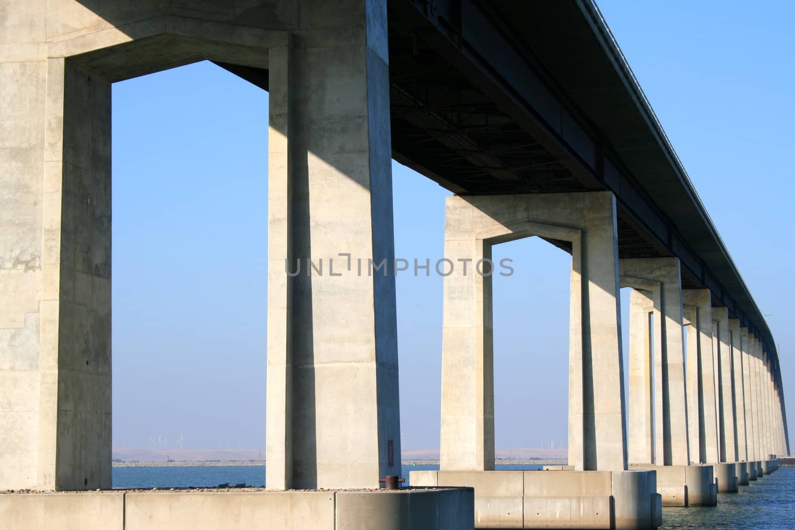 Long modern bridge built over a river.
