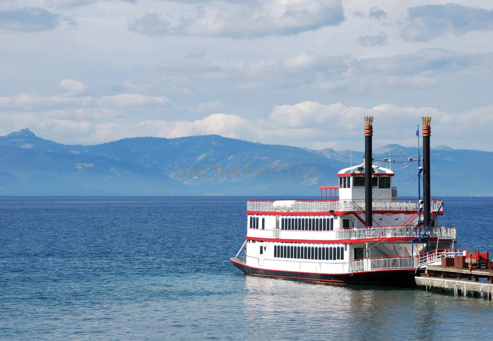 Paddle wheel boat docked on a lake