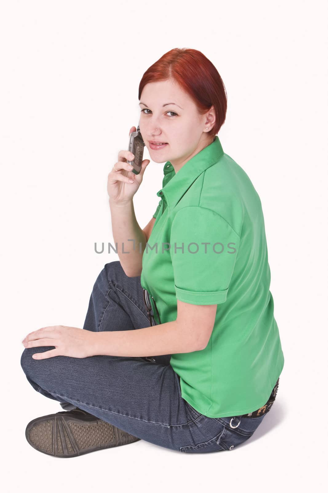 Image of a redheaded teenager girl using a mobile phone.