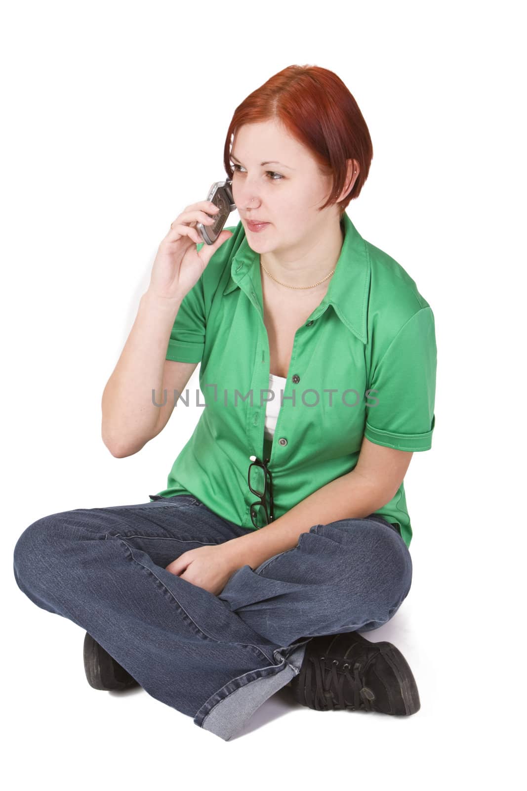 Image of a redheaded teenager girl using a mobile phone.