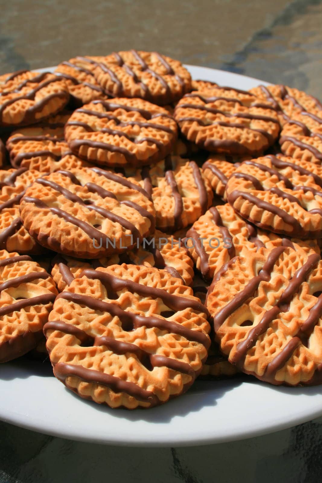 Close up of chocolate striped shortbread cookies on a plate.
