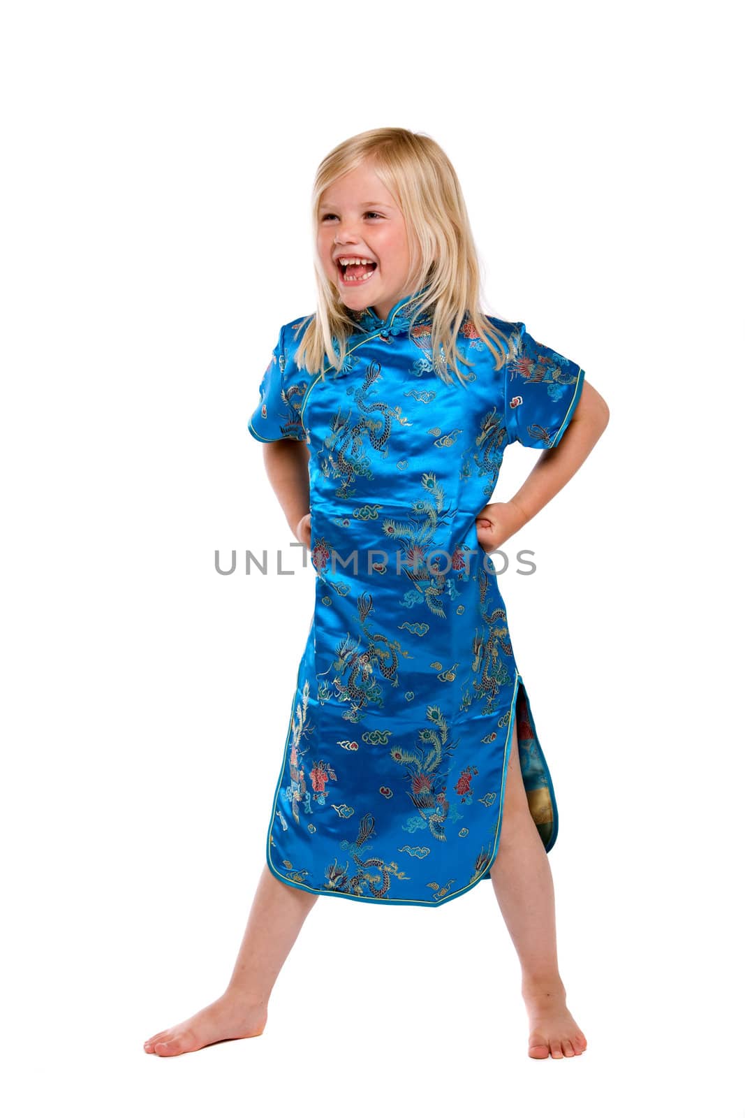 Pretty blond four year old girl having a good time and laughing