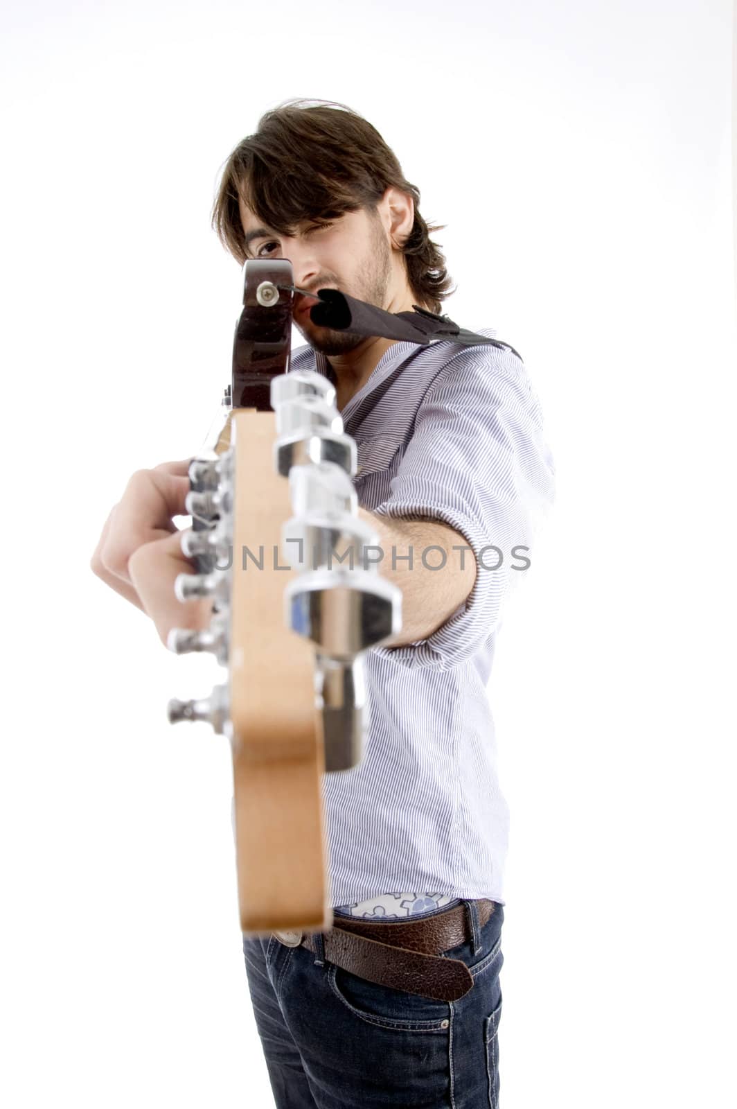 young fellow holding guitar like gun on an isolated white background