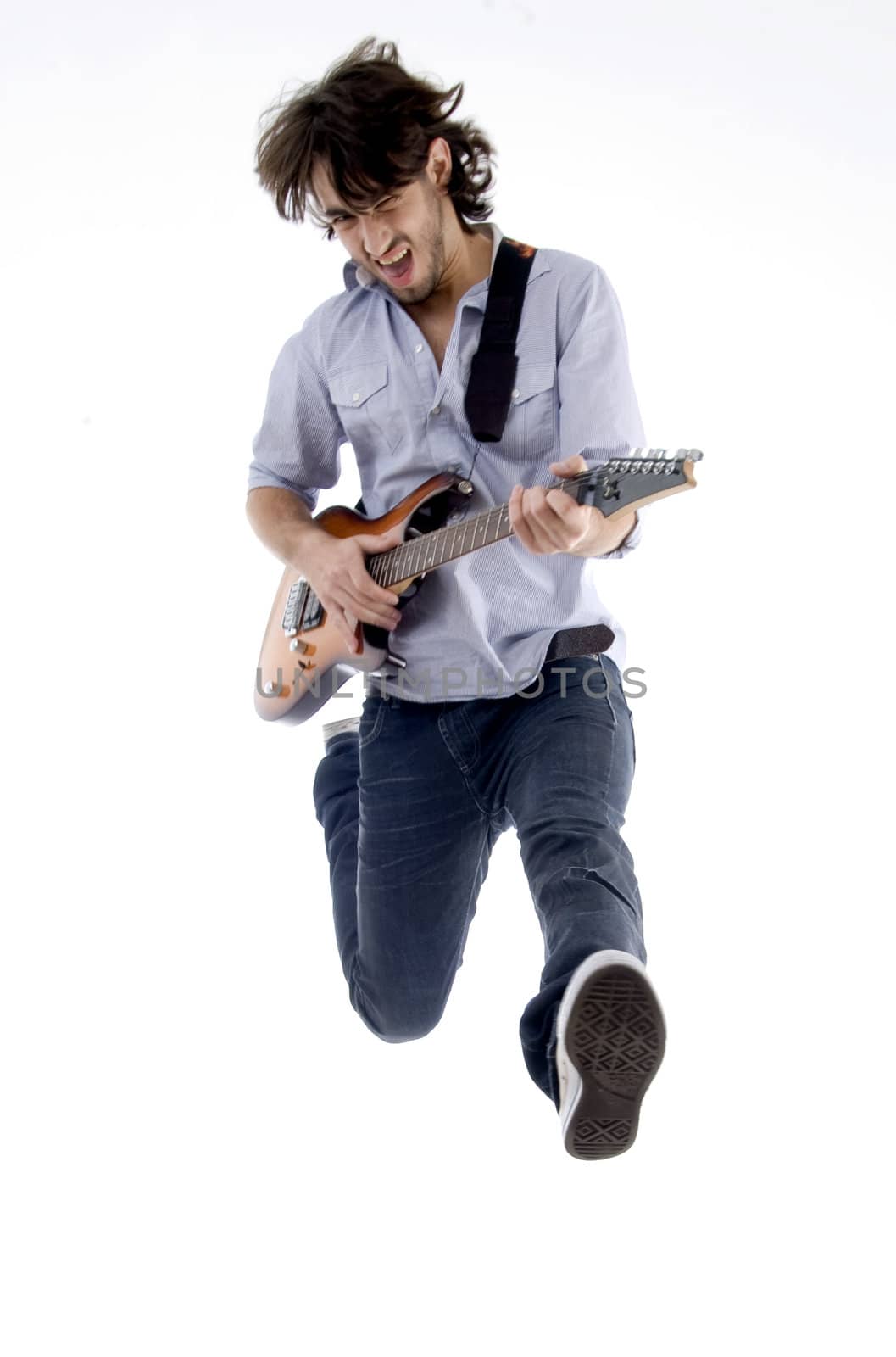 young male jumping high holding his guitar isolated on white background