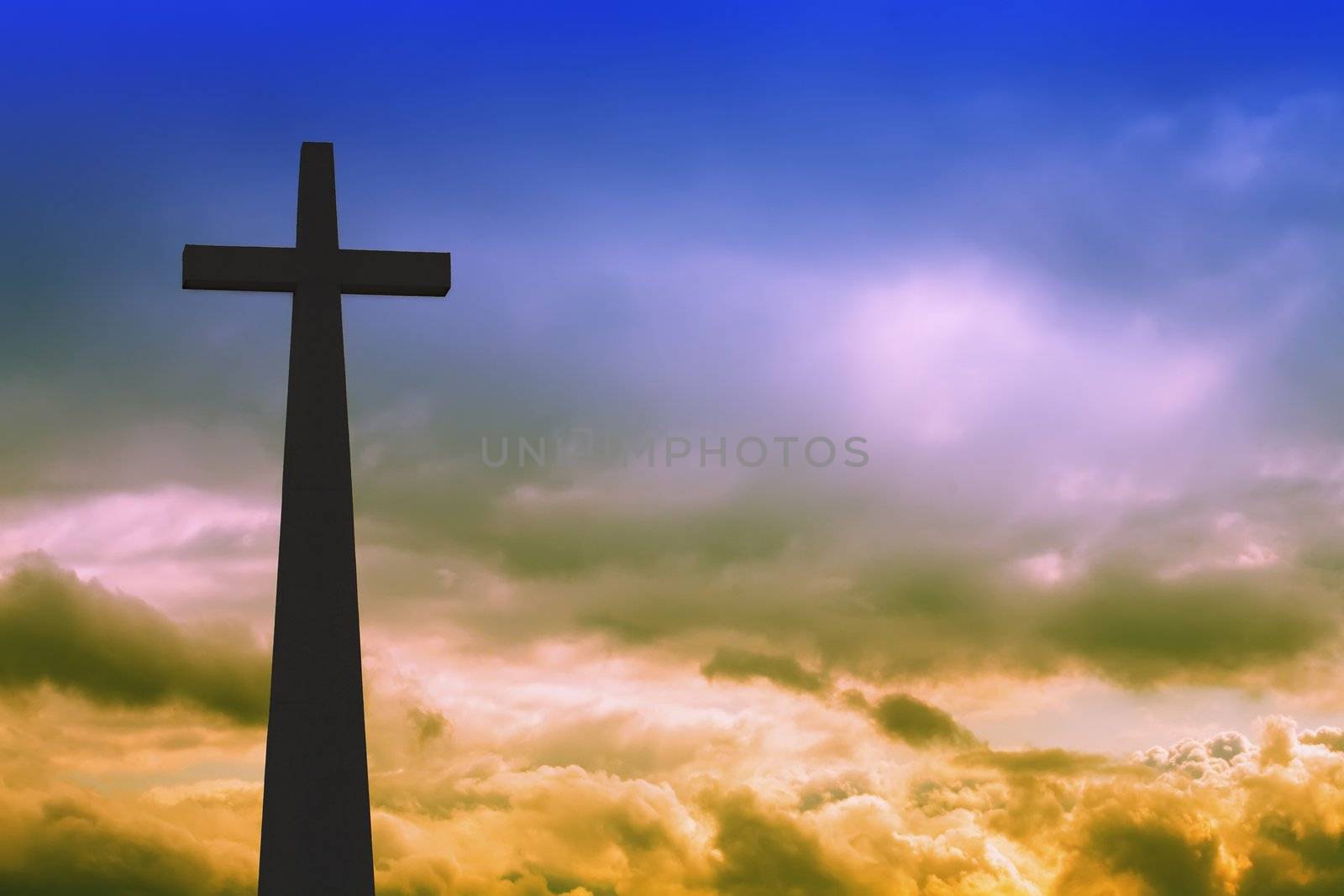 cross detail in silhouette and the clouds in the sky