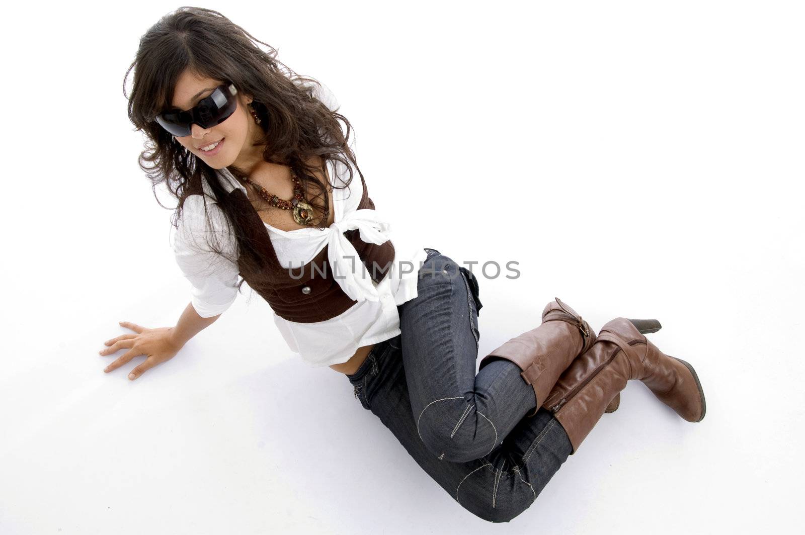 fashion model posing lying on floor on an isolated white background