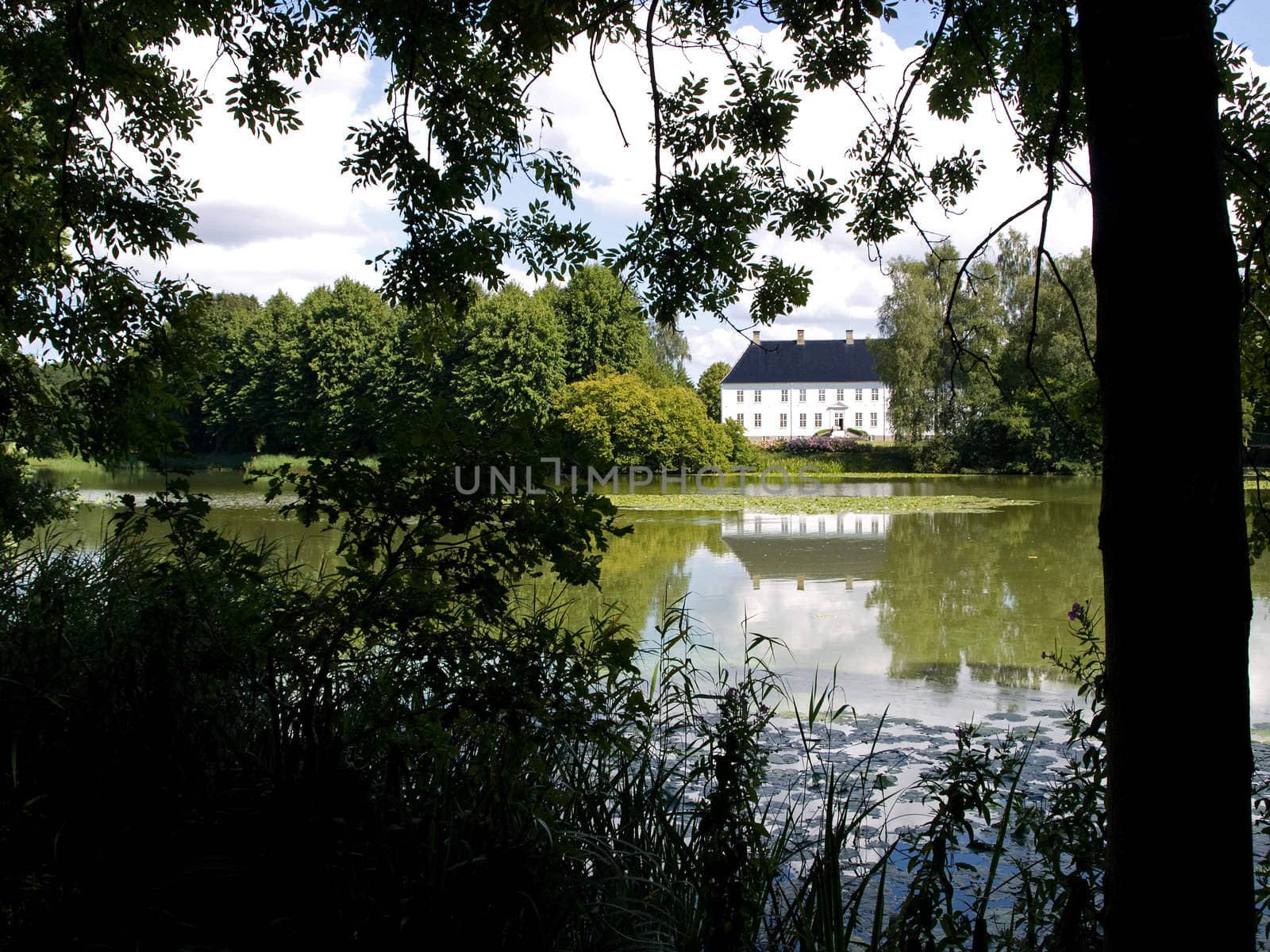 Beautiful landscape of a country mansion house by a lake Denmark