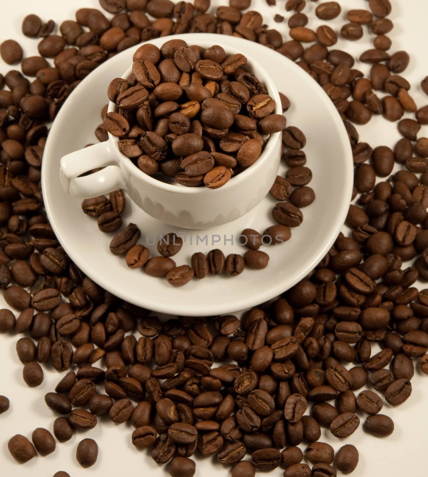 White china cup with roasted coffee beans by serpl