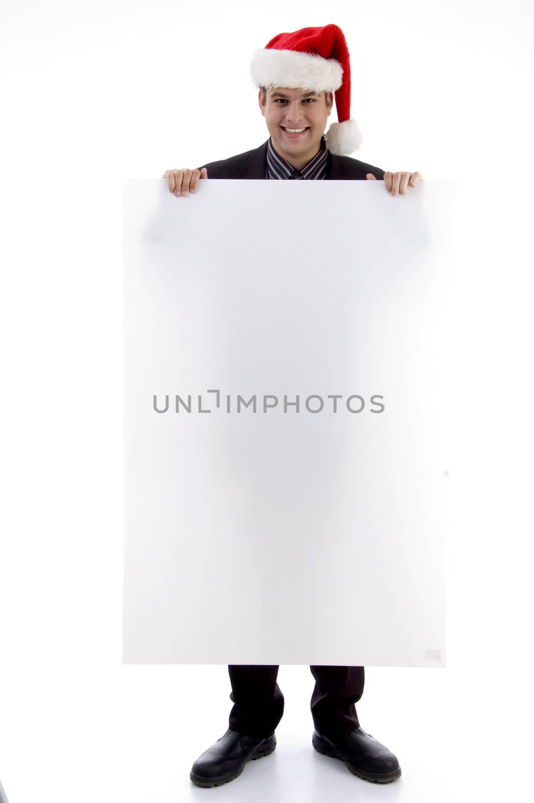 executive wearing christmas hat displaying placard against white background