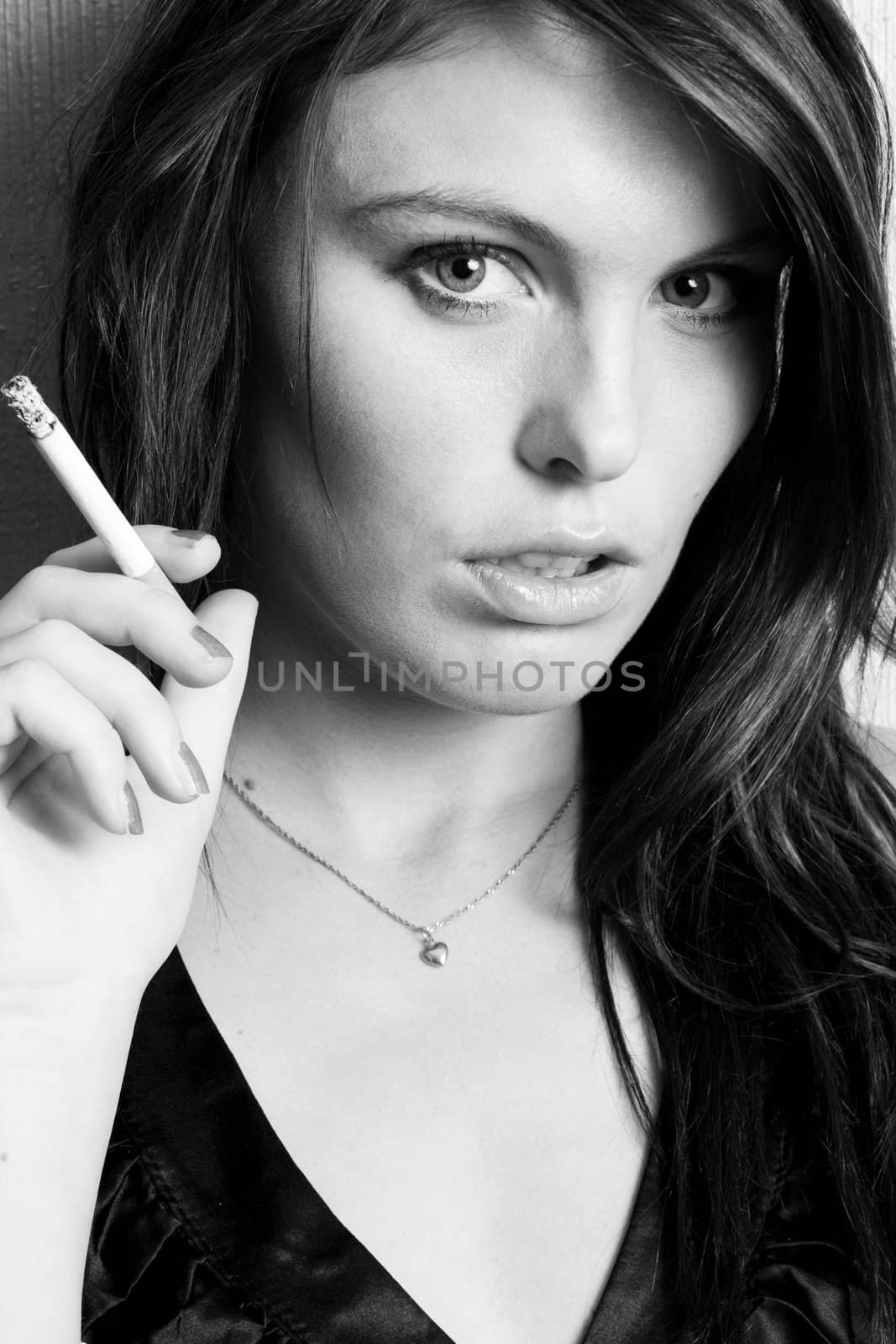 Portrait of beautiful young fashion model smoking a cigarette