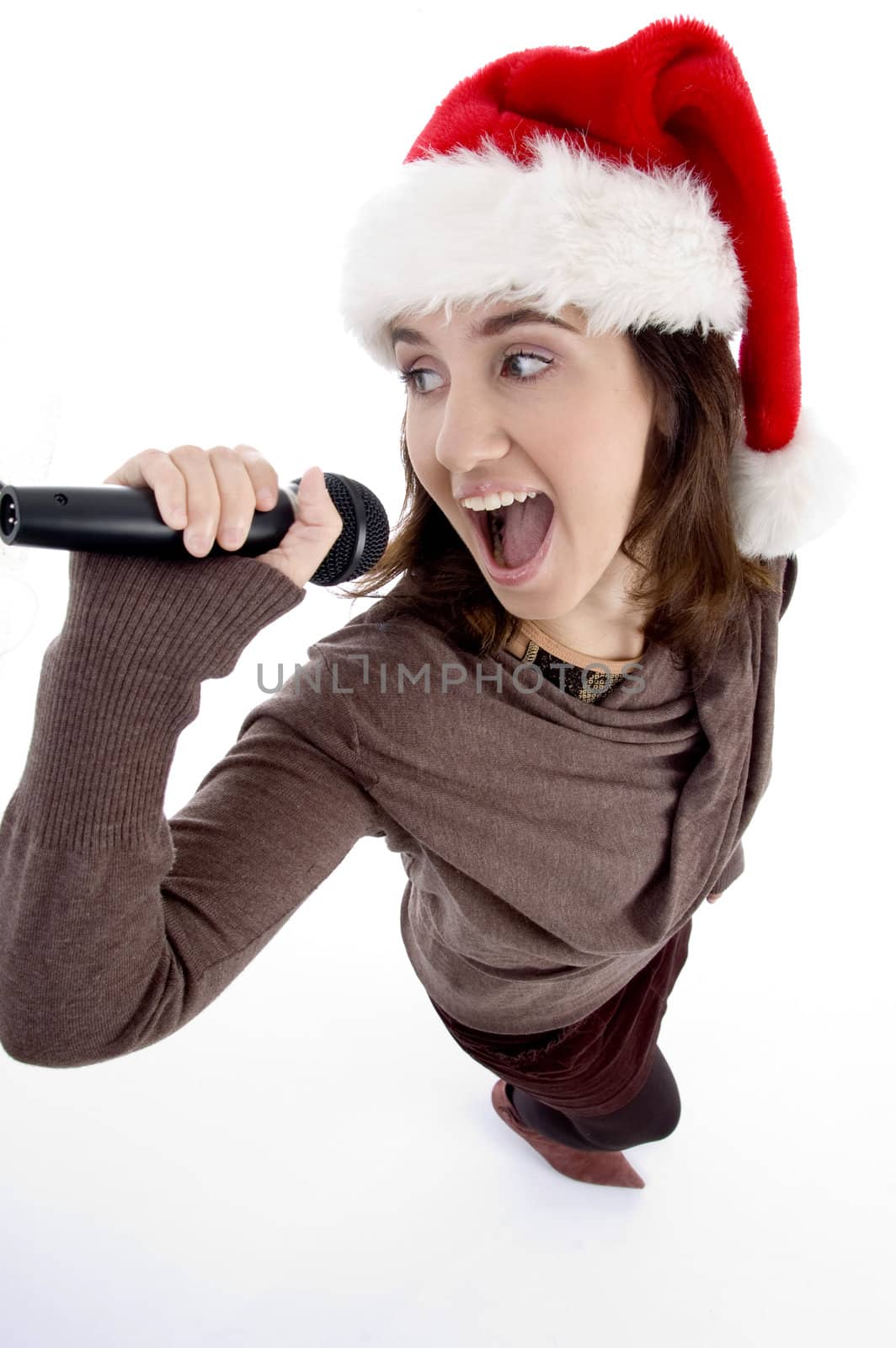 teen singer with mic and christmas hat on an isolated white background