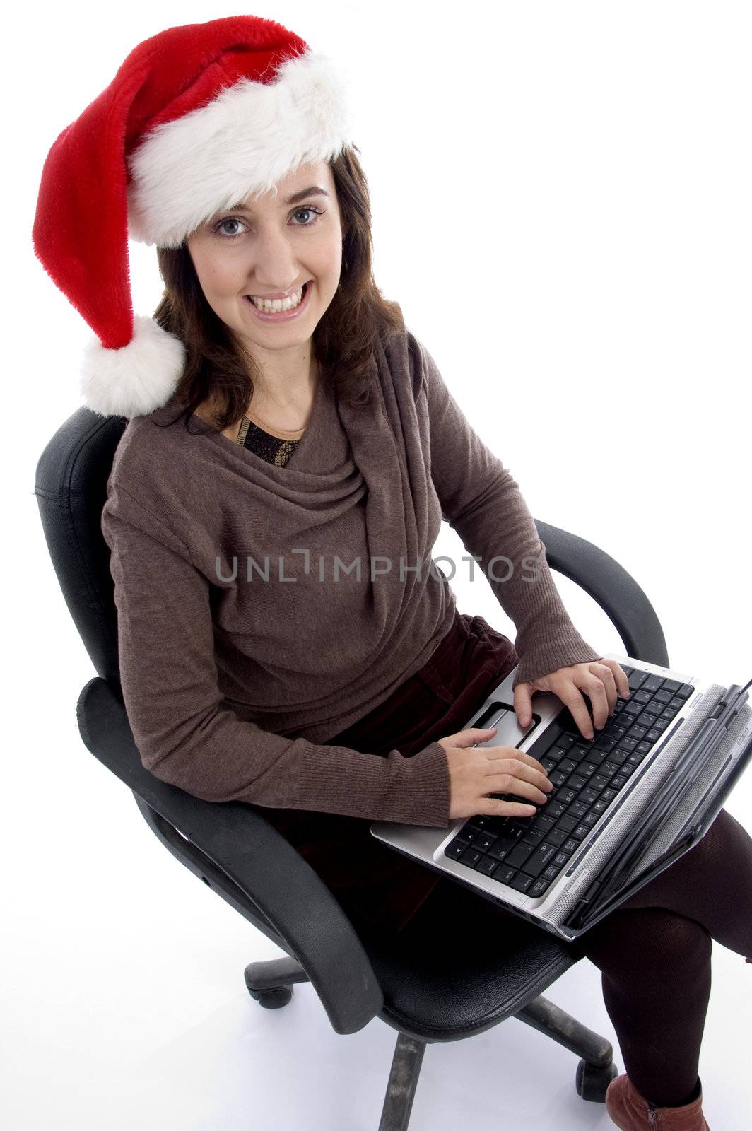 happy teenager busy with laptop looking at camera isolated on white background