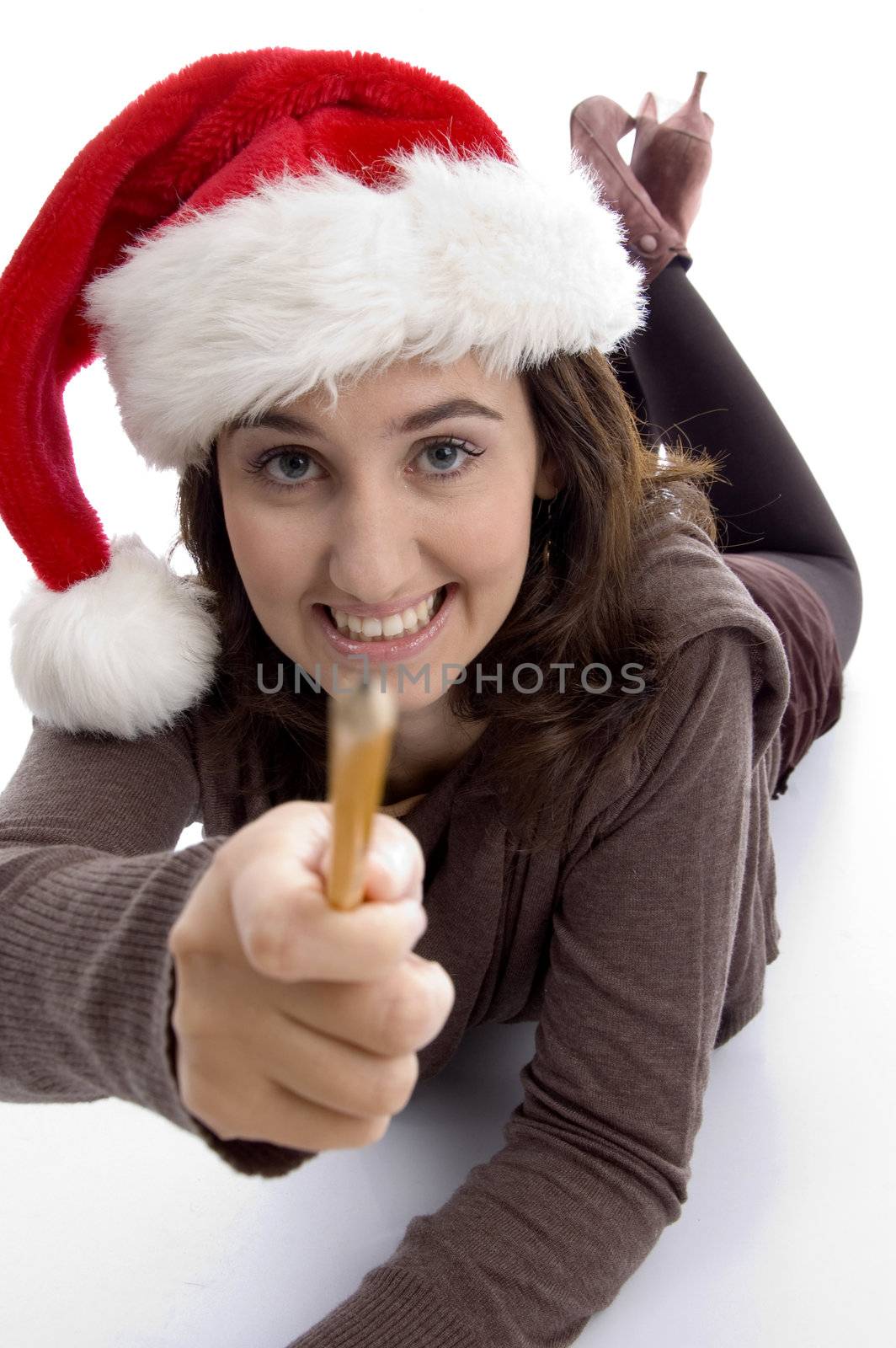 young student in christmas hat showing her pencil with white background
