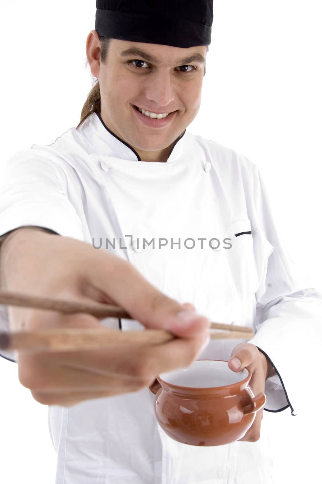 chef presenting chinese dish with chopstick against white background