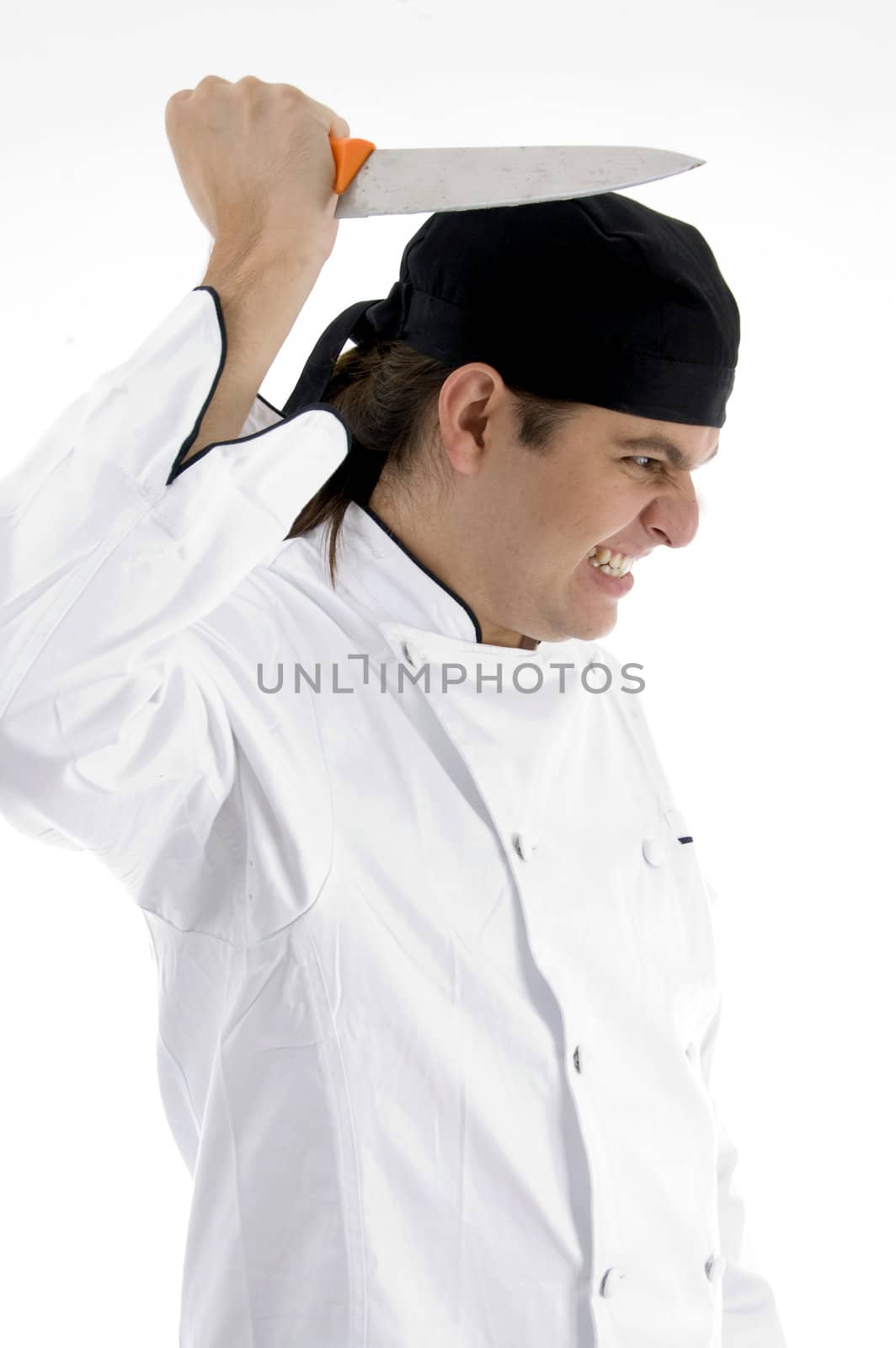 angered chef posing with knife against white background