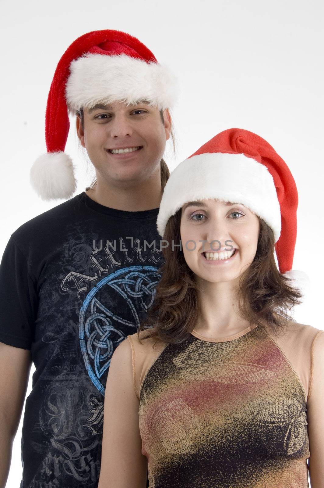 happy young couple wearing christmas hat by imagerymajestic