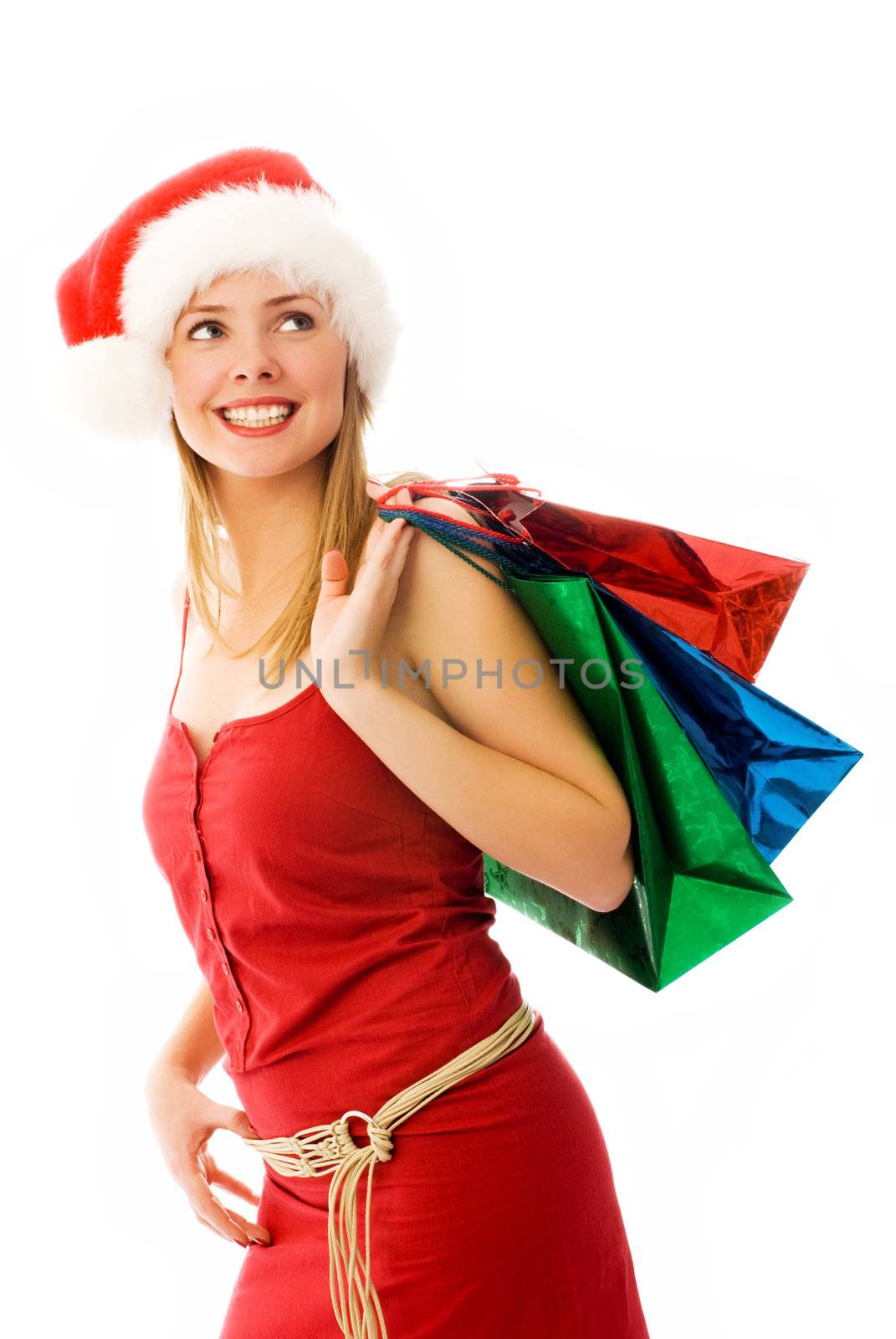girl wearing Santa's hat with Christmas presents
