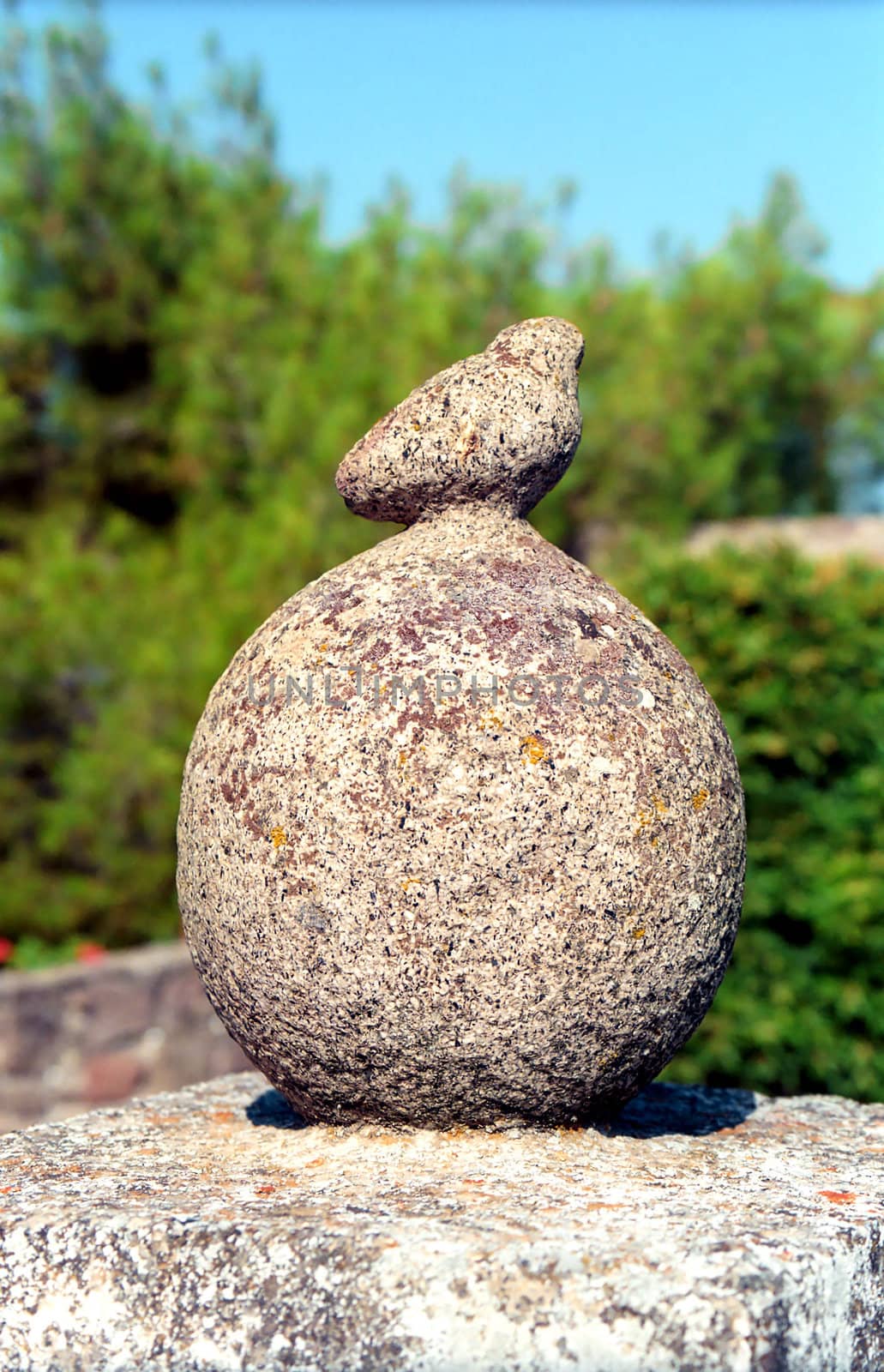 Stone bird on a ball as a decorative detail of a house
