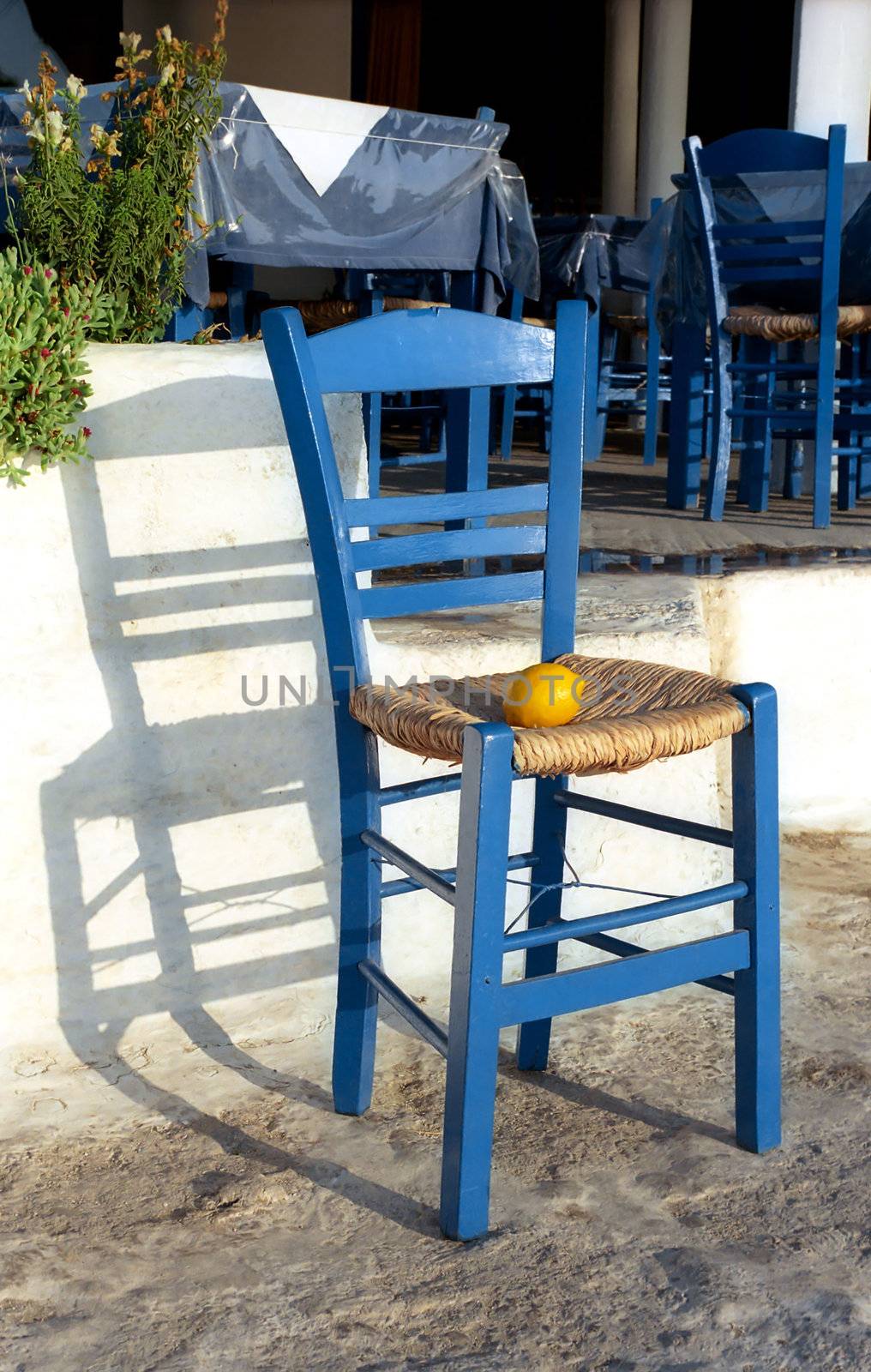 Blue chair with lemon on background of cafe
