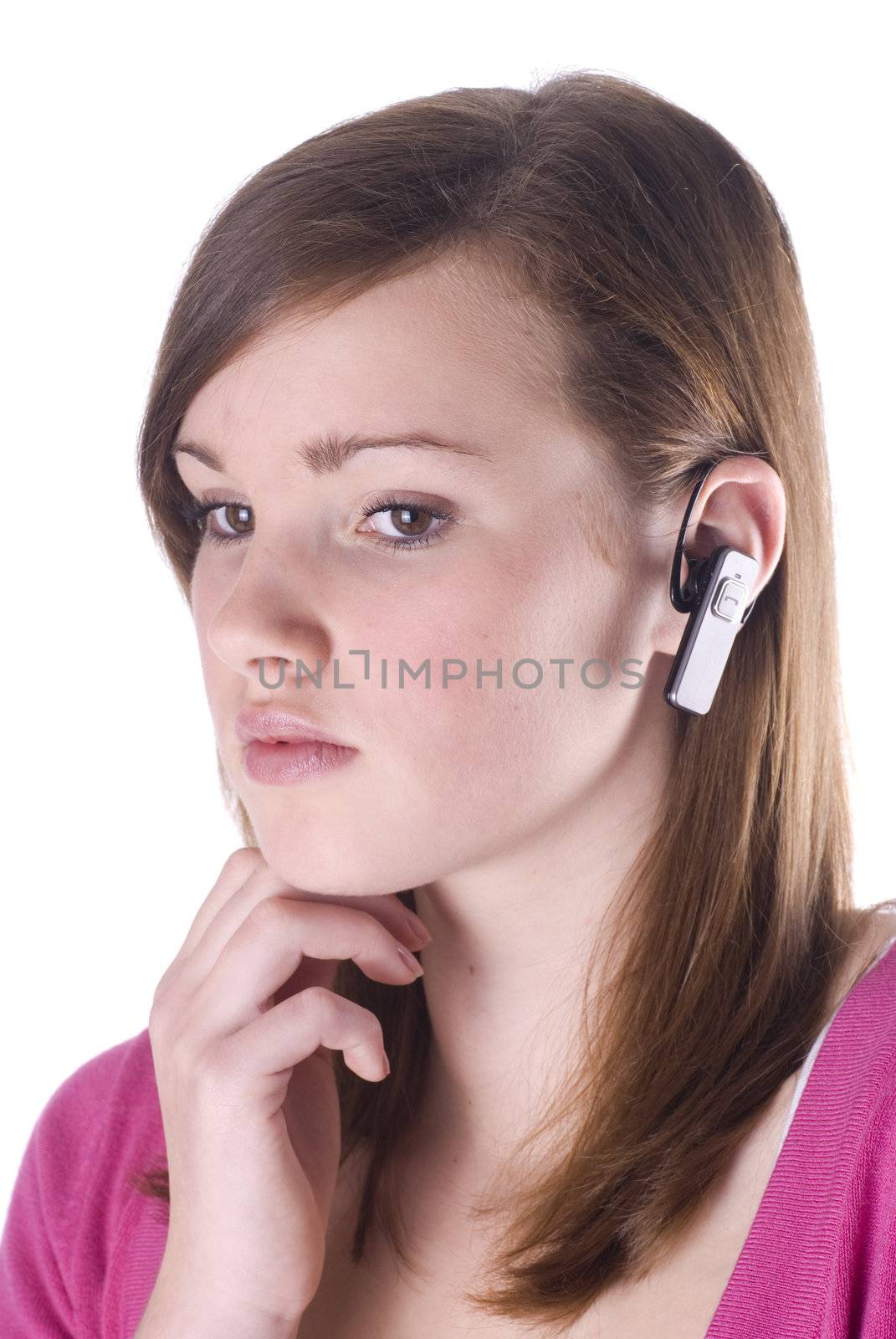 Teenage girl with wireless headset isolated on a white background.