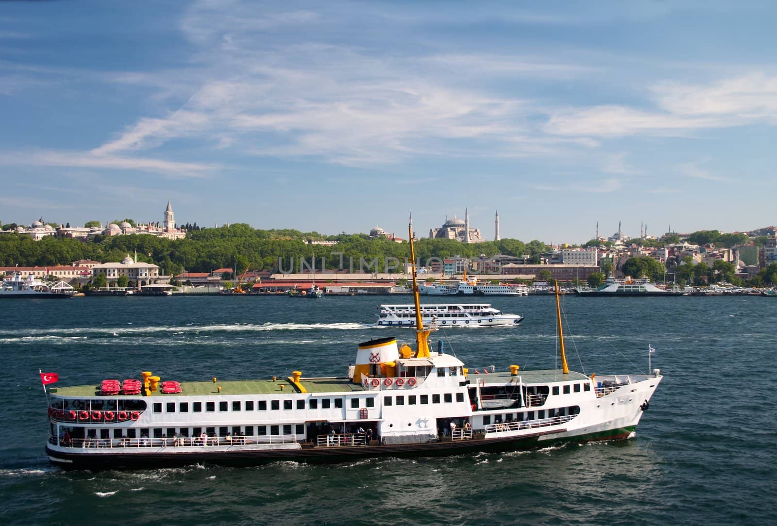 pleasure boat in Bosporus against a background of mosques