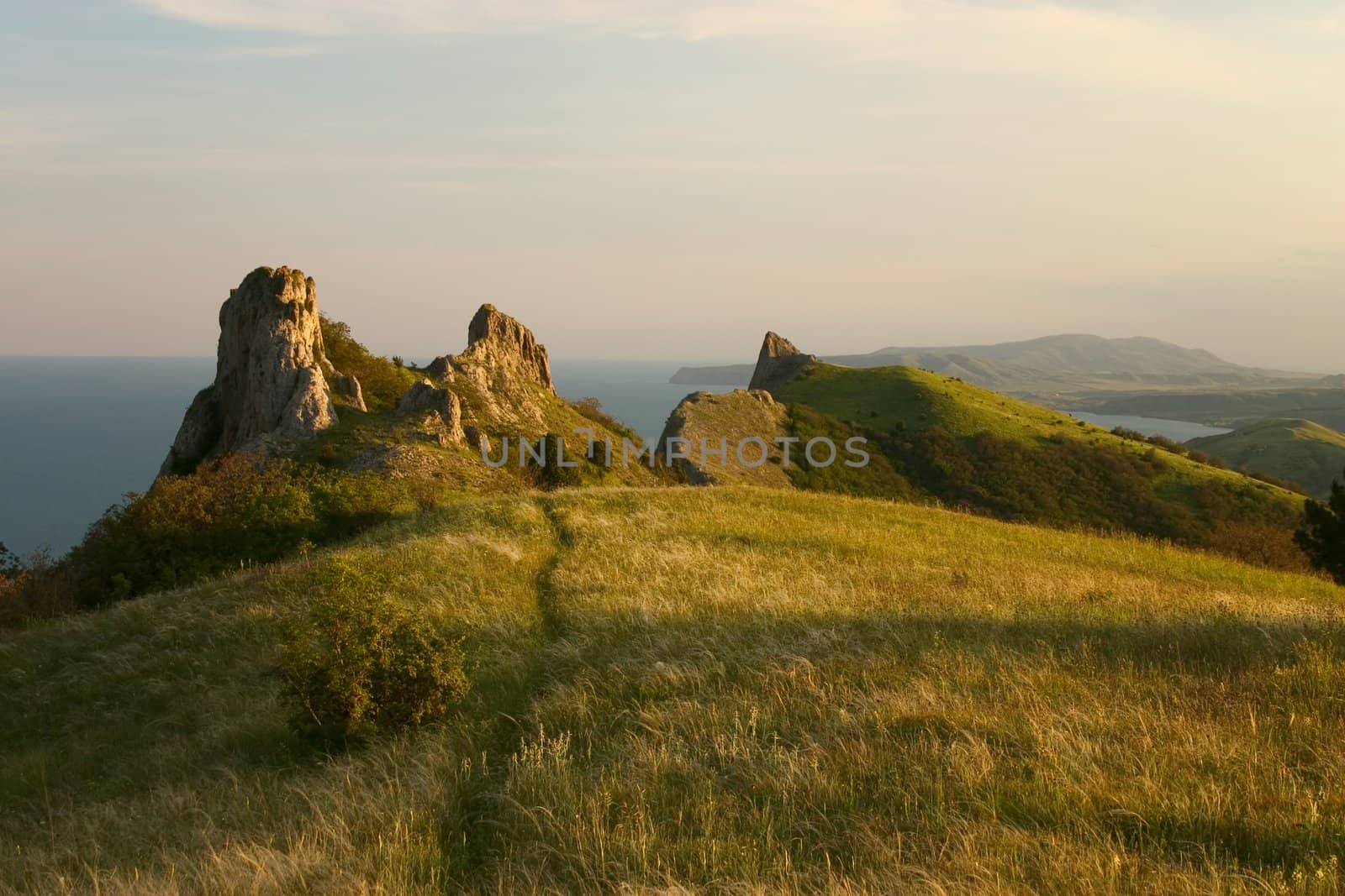 Rocks and grass lighted up bu evening sun