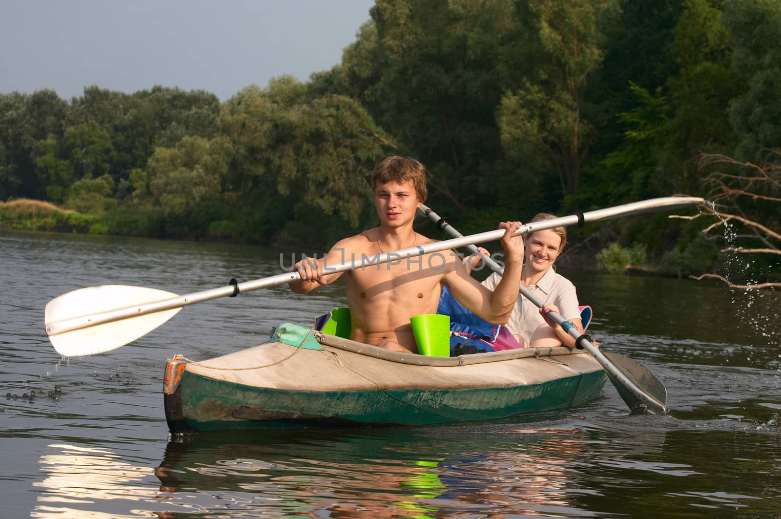 young couple kayaking on the river