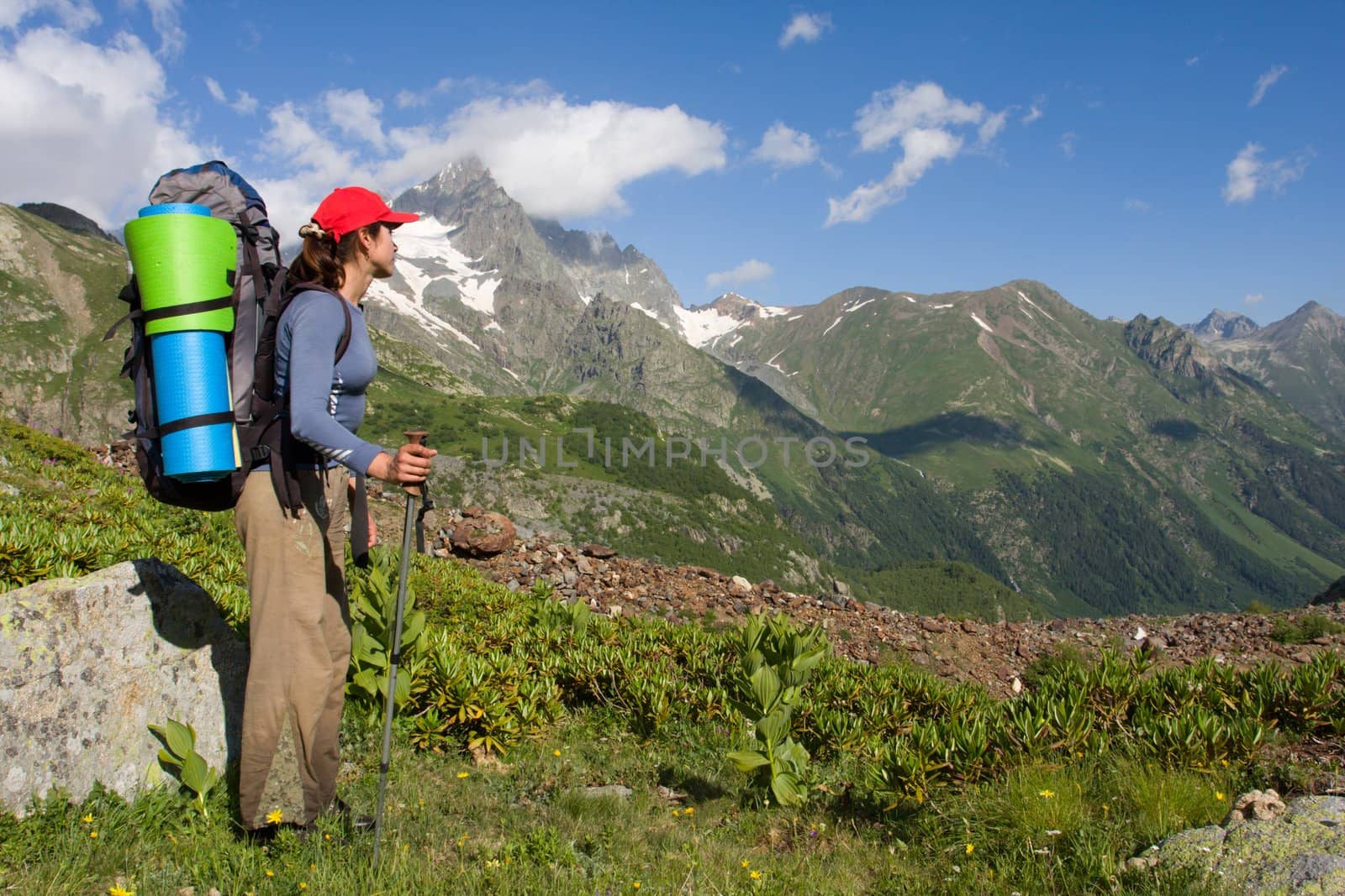 Backpacker woman looking to a valley in Caucasus mountains