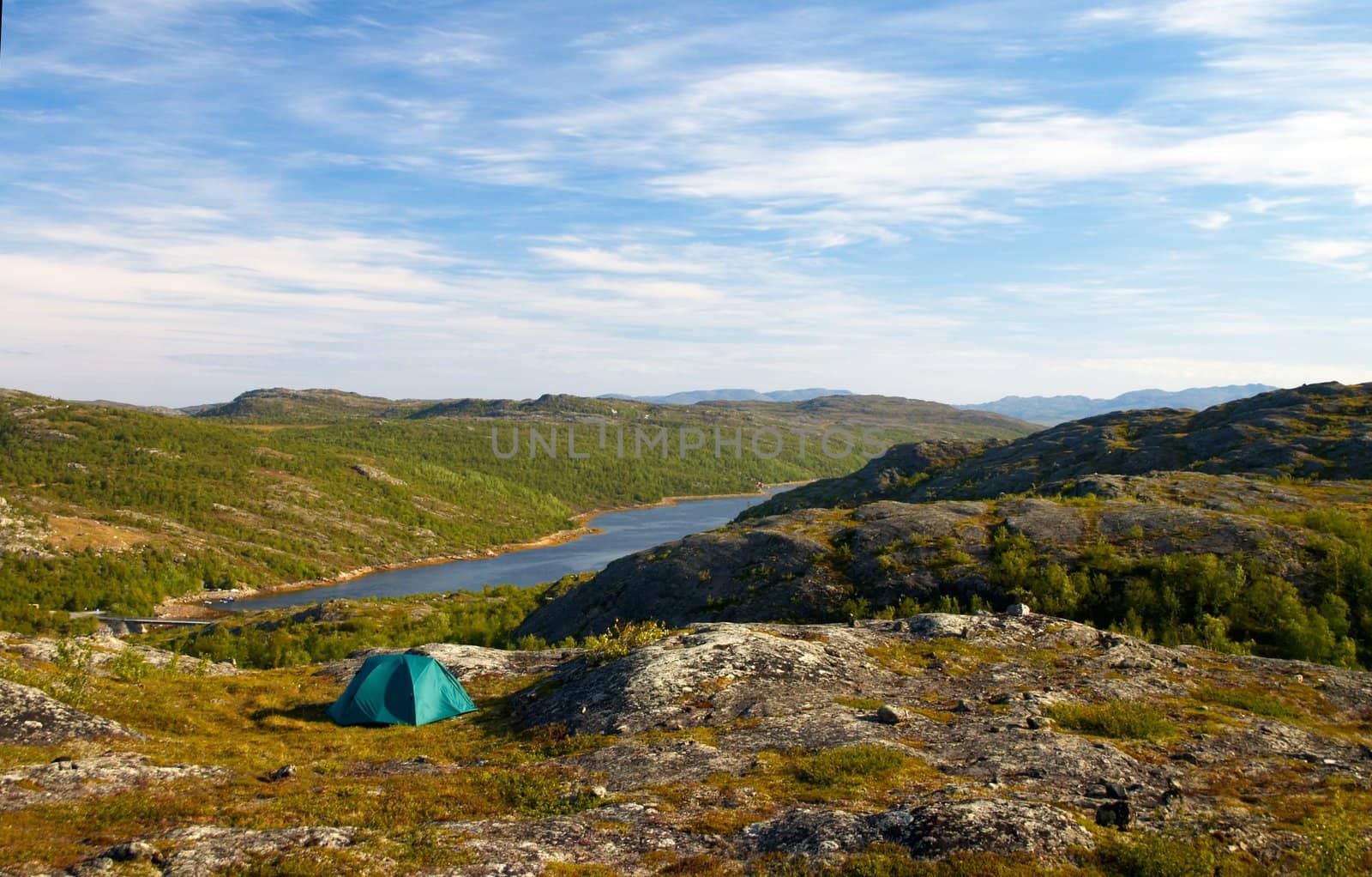 green tent on a fiord coast in north norway
