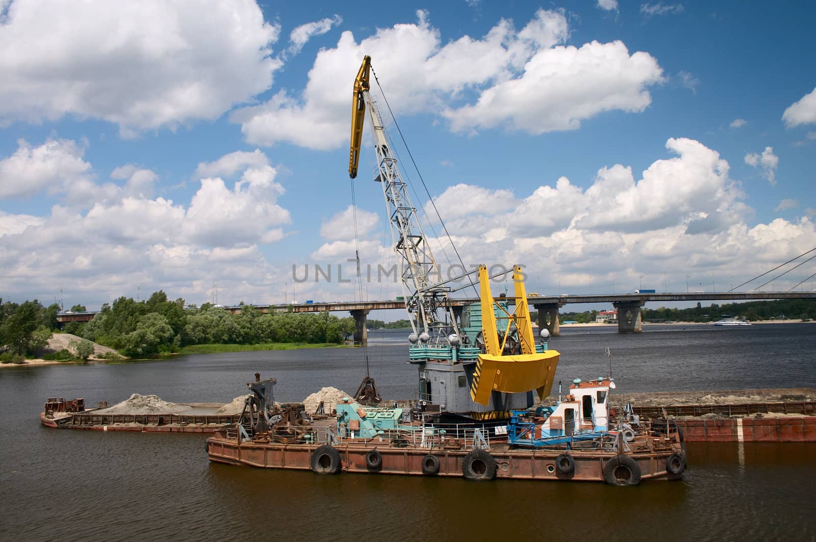 hydraulic dredge on barge in the working river