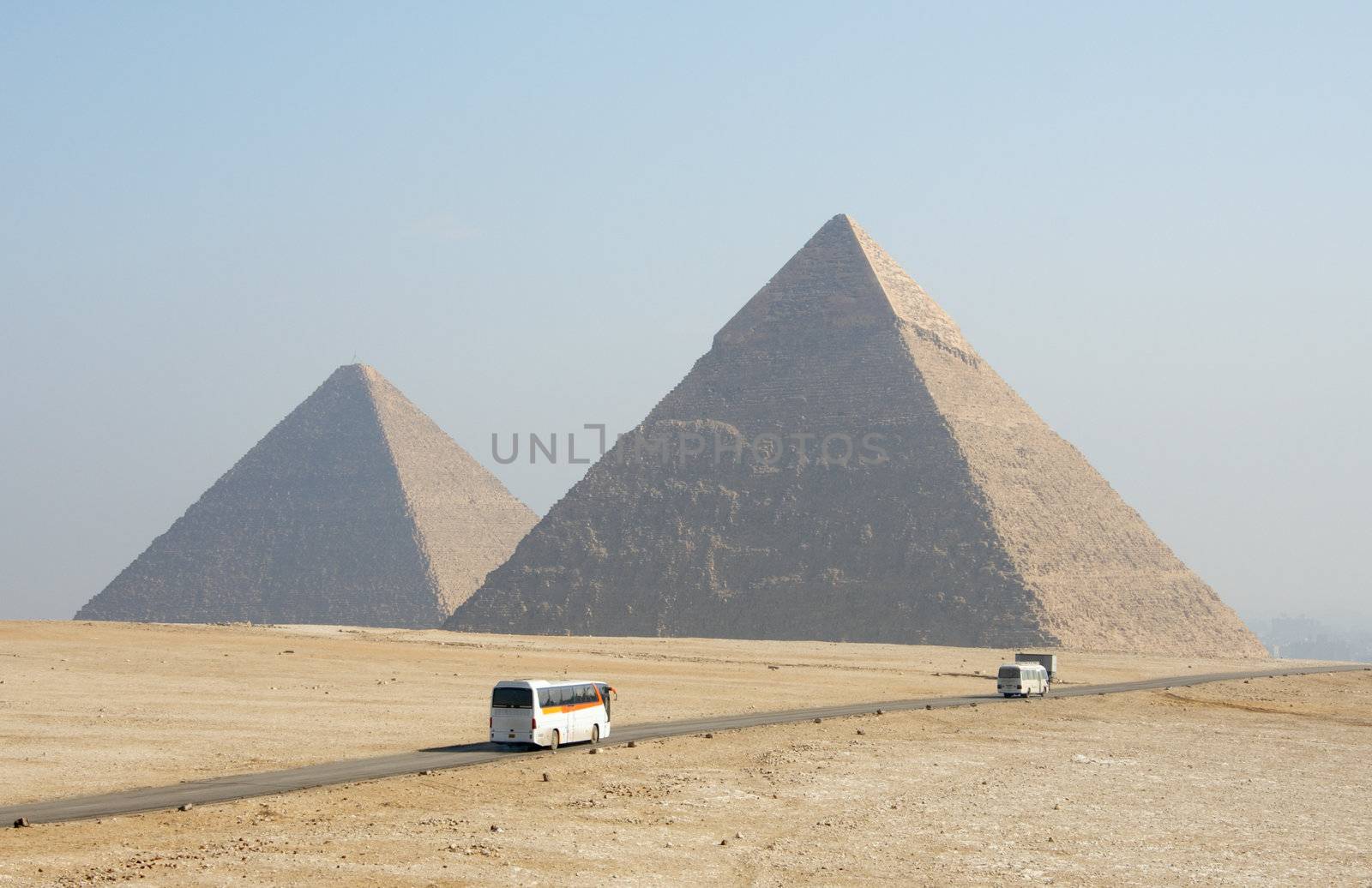 egypt pyramids in Sahara desert and road with bus