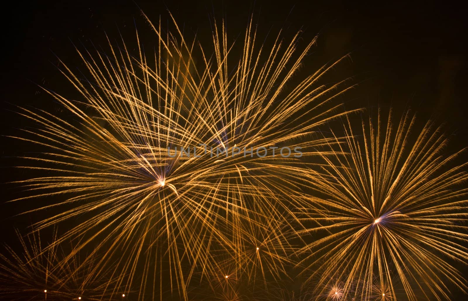 Yellow fireworks stars in black sky