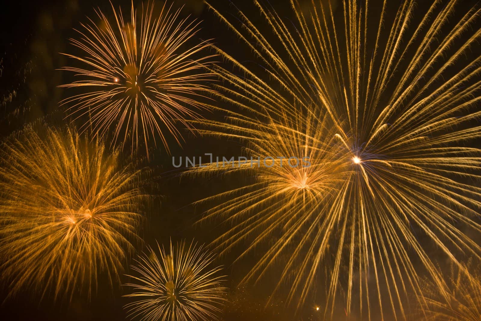 Orange fireworks stars in night sky