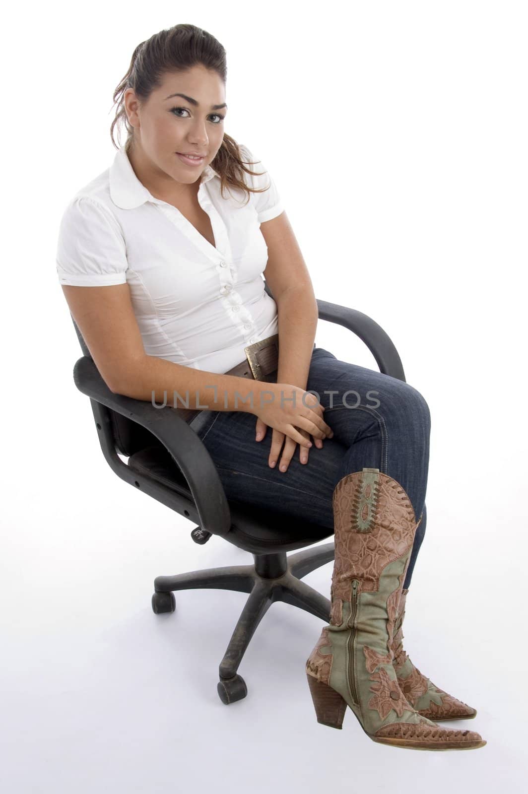 young pretty sitting on the chair and facing to camera against white background