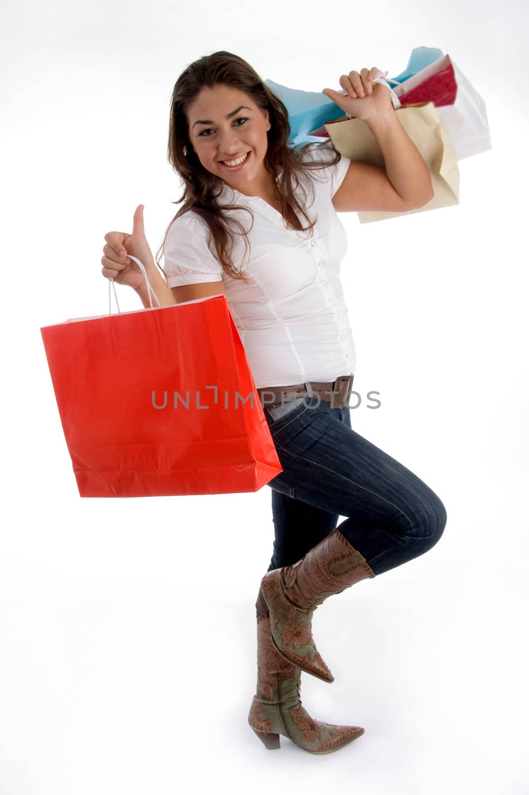 happy girl holding shopping bags on an isolated white background