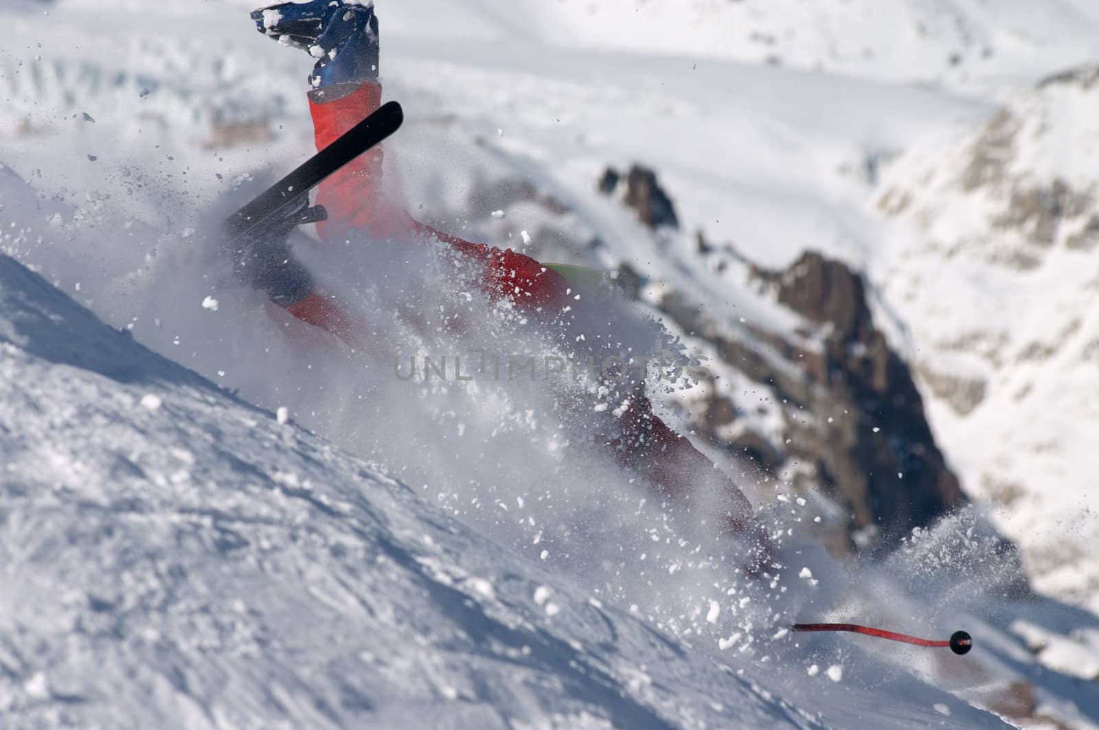 skier falling down the hill on the clouds of snow powder