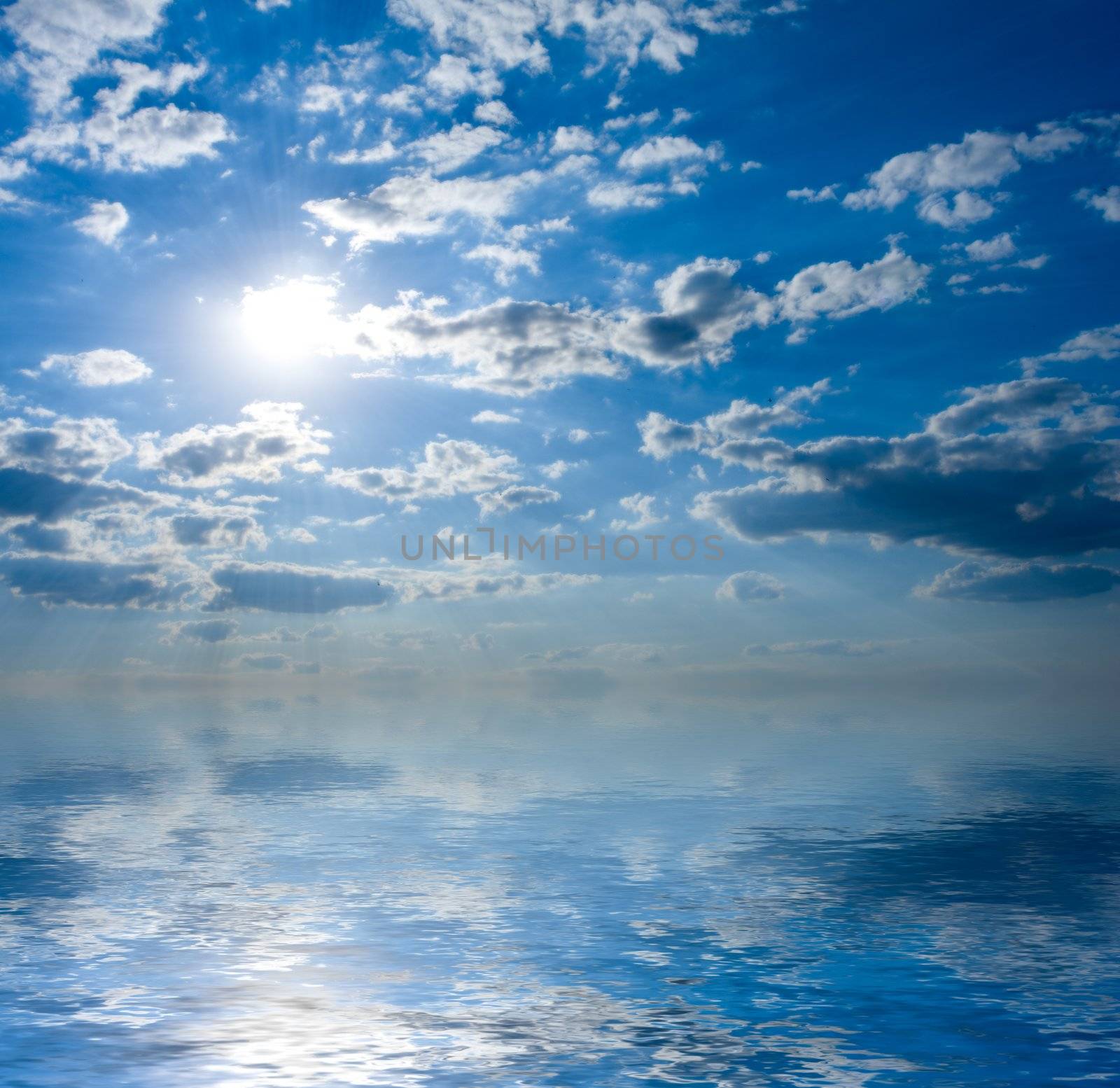 Seascape with sun in blue sky