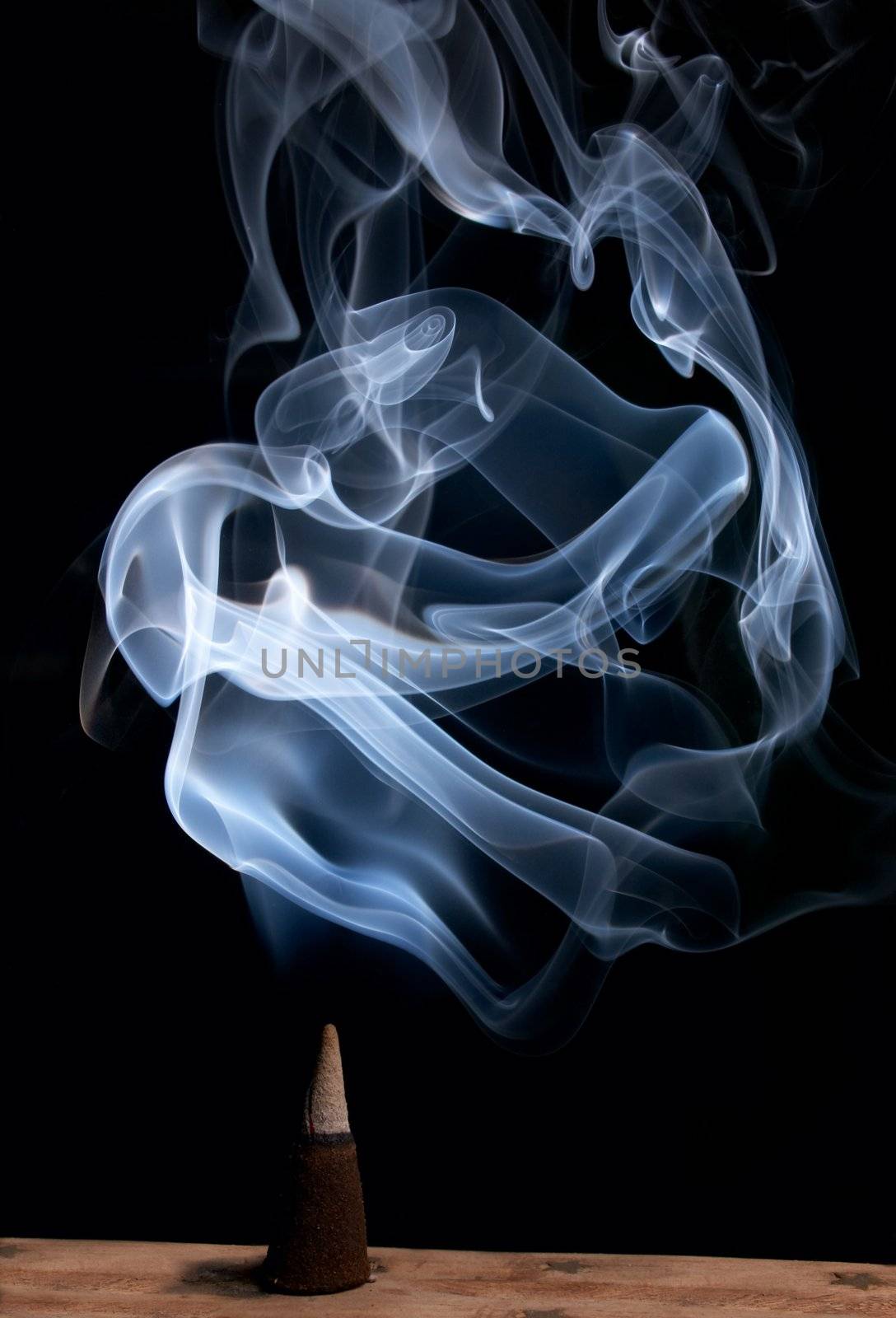 burning incense cone with smoke