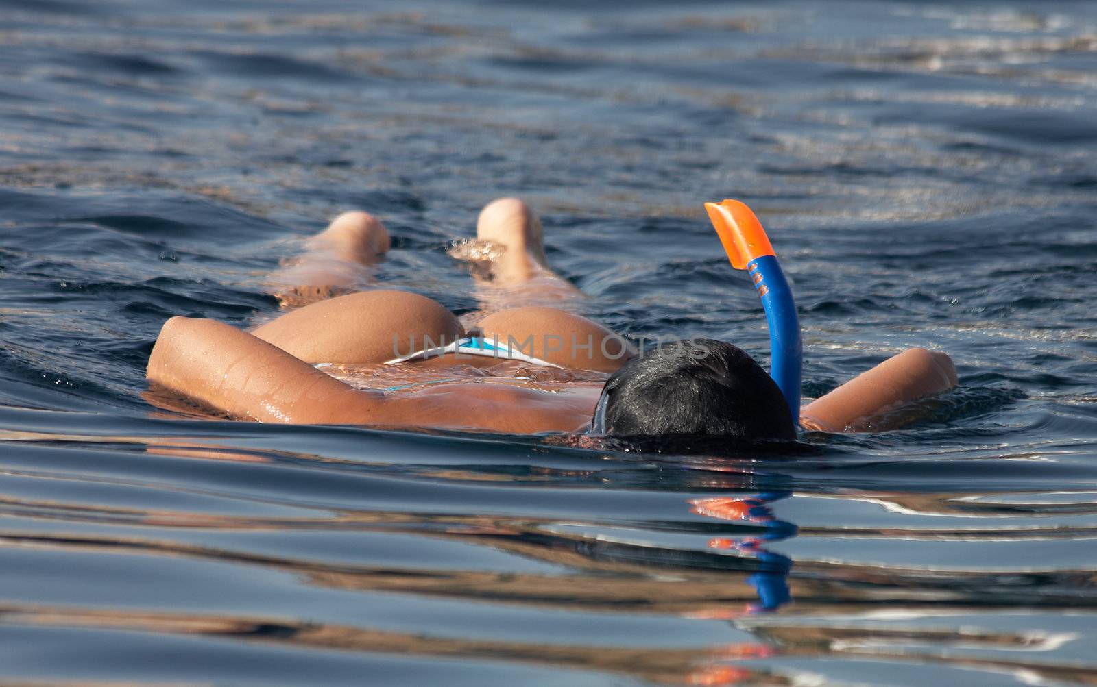 girl swimming with snorkel in the sea