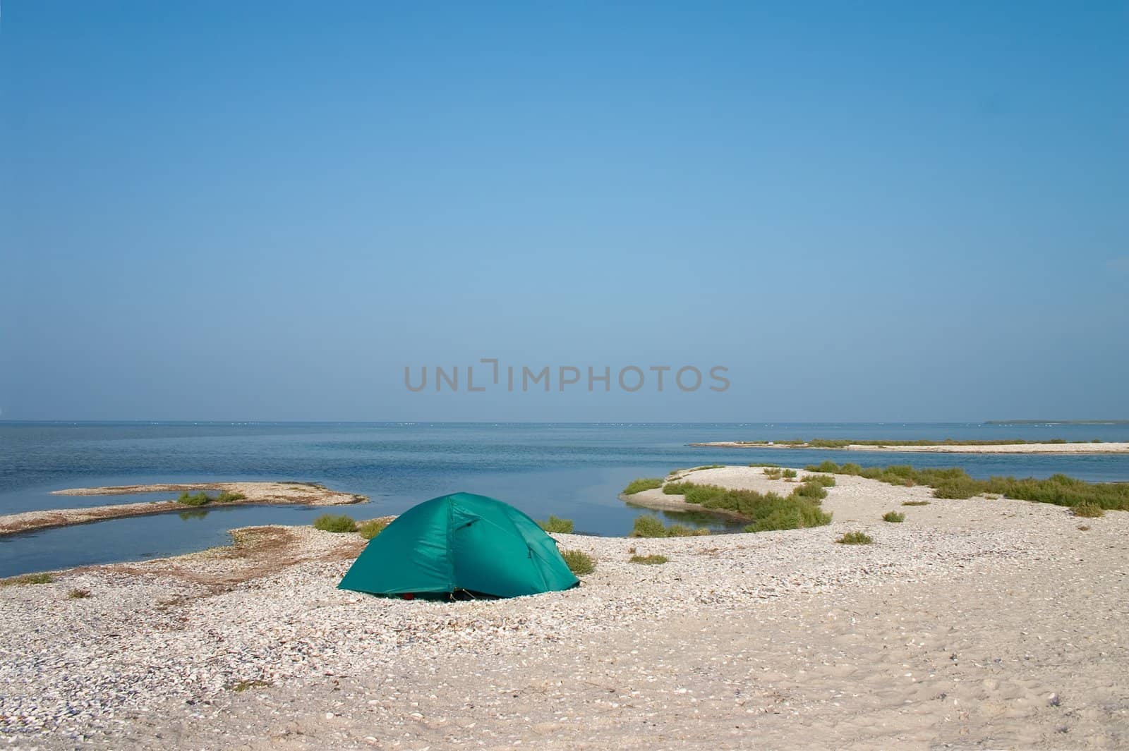 Loneline tent on the sandbank at seaside